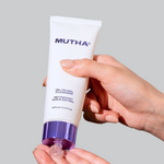 Image of hand squeezing a bottle of the Oil-to-Gel Cleanser to squirt product in the hand