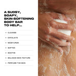 Hand holding a sudsy body bar with text listing benefits on a white background
