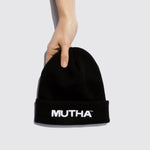Image of a hand holding the MUTHA Beanie