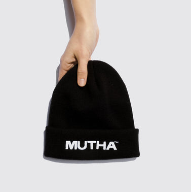 Image of a hand holding the MUTHA Beanie