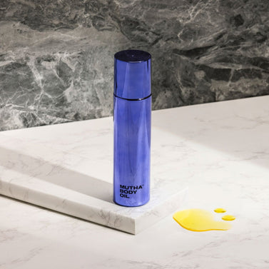 Stylish image of the Body Oil on a marble block in front of a model background , 25ml / 0.8 fl oz , 100ml / 3.4 fl oz
