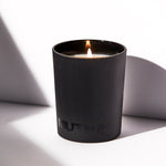 Image of the lit MUTHA™ F* Racism Candle