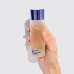 Image of a hand holding the Rebirth Amniotic Toner