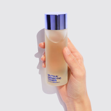 Image of a hand holding the Rebirth Amniotic Toner