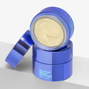 Blue jar of Mutha Body Butter on a light gray background