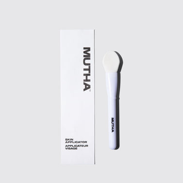 White skin applicator with 'MUTHA' branding on a light gray background